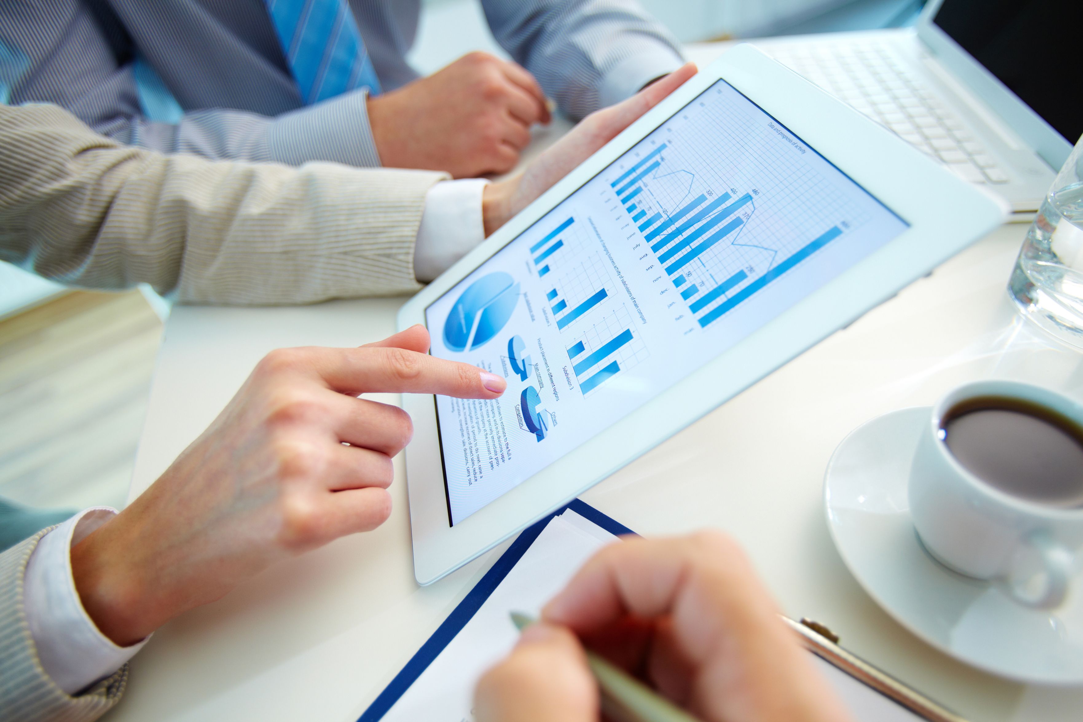 Business people lookig at data on a tablet