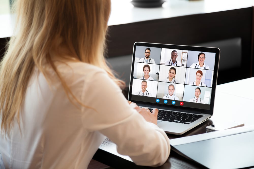 Woman having an online meeting with a team of veterinarians